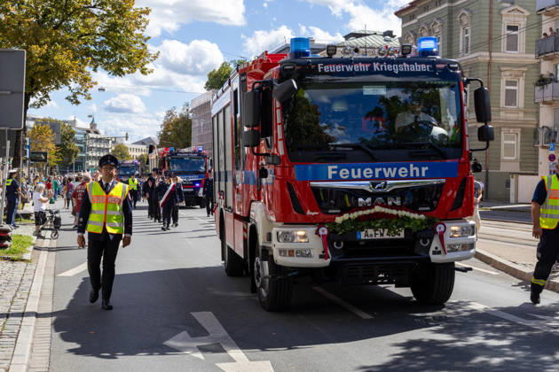 Augsburg, Bavaria, Germany - August 29, 2026: Traditional Plärrer parade in Augsburg. The Kriegshaber Fire Department is participating in the traditional Plärrer parade through Augsburg with a decorated fire truck and firefighters in uniform, marching through the city center
