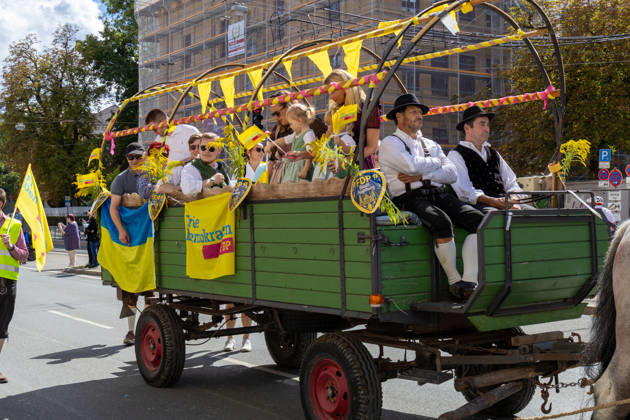 Augsburg, Bavaria, Germany - August 29, 2026: Traditional Plärrer parade in Augsburg. Members of the FDP in Augsburg take part in the traditional Plärrer parade through Augsburg with a decorated float, party flags, and yellow banners. A Ukrainian flag is also visible