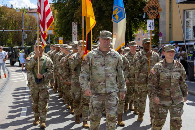 Augsburg, Bavaria, Germany August 29, 2026: Traditional Plärrer parade in Augsburg. U.S. Army soldiers, wearing camouflage uniforms and carrying both the American and German flags, take part in the traditional Plärrer parade through Augsburg and march through the city center