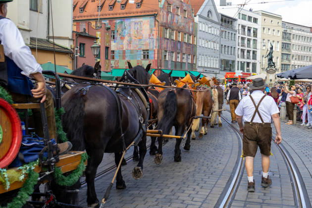 Augsburg, Bavaria, Germany August 29, 2026: Traditional Plärrer parade in Augsburg. A traditional horse-drawn procession featuring decorated draft horses and parade floats winds its way through downtown Augsburg during the Plärrer parade. Numerous spectators line the parade route