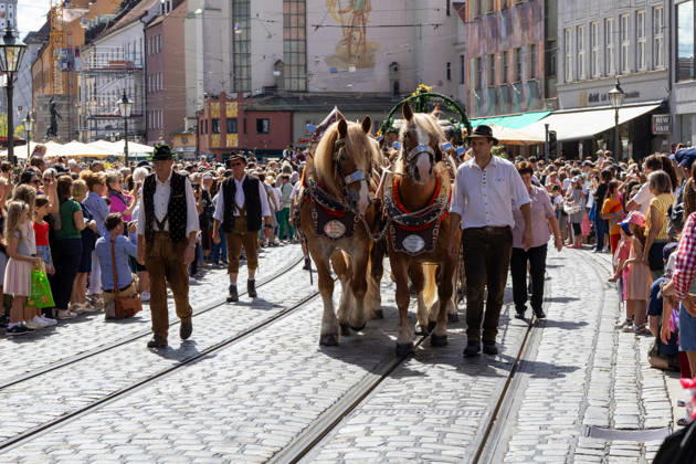 Augsburg, Bavaria, Germany August 29, 2026: Traditional Plärrer parade in Augsburg. A traditional horse-drawn procession featuring decorated draft horses and parade floats winds its way through downtown Augsburg during the Plärrer parade. Numerous spectators line the parade route