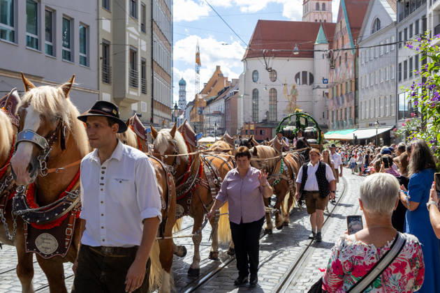 Augsburg, Bavaria, Germany August 29, 2026: Traditional Plärrer parade in Augsburg. A traditional horse-drawn procession featuring decorated draft horses and parade floats winds its way through downtown Augsburg during the Plärrer parade. Numerous spectators line the parade route