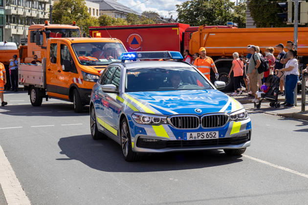 Augsburg, Bavaria, Germany - August 29, 2026: Traditional Plärrer parade in Augsburg. Police, public safety, and emergency vehicles secure the route during the traditional Plärrer parade in Augsburg. Roadblocks and emergency personnel ensure safety along the parade route
