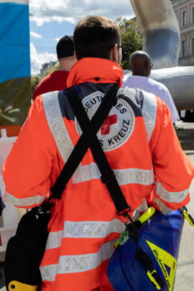Augsburg, Bavaria, Germany August 29, 2026: Traditional Plärrer parade in Augsburg. A volunteer from the German Red Cross (DRK) stands on the side of the road during the traditional Plärrer parade in Augsburg. Emergency responders are providing medical support for the event