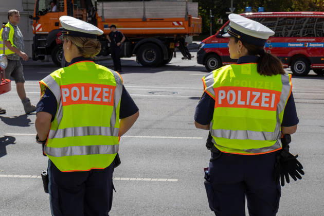 Augsburg, Bavaria, Germany - August 29, 2026: Traditional Plärrer parade in Augsburg. Police officers secure the route during the traditional Plärrer parade in Augsburg and ensure order, traffic safety, and the protection of participants and spectators