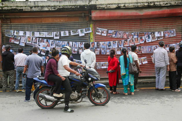 Passersby View Flood Victims Photos - Kathmandu Passersby look at photographs of people who died in the floods, displayed outside a hospital in Kathmandu, Nepal on August 30, 2026. Photo by Sunil Pradhan ABACAPRESS.COM Kathmandu Bagmati Nepal  Copyright: xSuniixPradhan ABACAx