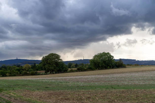Showery weather in late summer: Dark clouds from a shower are visible in the evening sky over the Taunus Mountains, Oberursel, Hesse, Germany