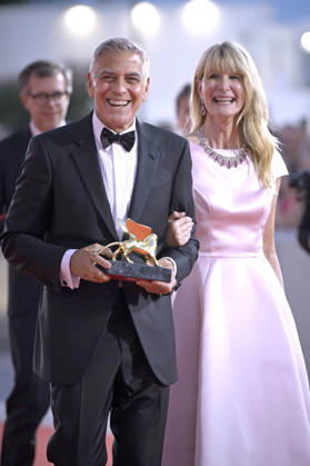George Clooney poses on the red carpet with Laura Dern after receiving the Golden Lion for Lifetime Achievement Award during the Opening Ceremony the 83rd Venice International Film Festival at Sala Grande on September 2, 2026 in Venice, Italy. VFF20260902870 RoccoxSpaziani