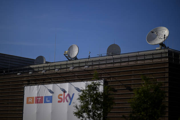 RTL Deutschland headquarters at Rheinpark Metropole, featuring a banner with the RTL and Sky logos and a satellite dish on the roof, on August 26, 2026, in Cologne, Germany