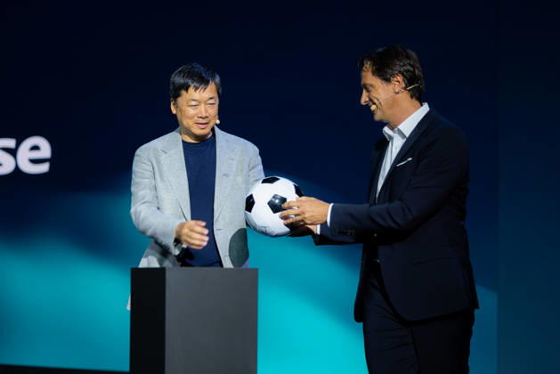 Hisense Press Conference at IFA Germany, Berlin, on September 3, 2026. Hanson Han, CEO of Hisense Europe, and Guillaume Sabran, Chief of Sponsorship and Licensing at UEFA, holding a soccer ball. Hisense is an official sponsor of the 2028 UEFA Euro soccer tournament in the UK and Ireland.