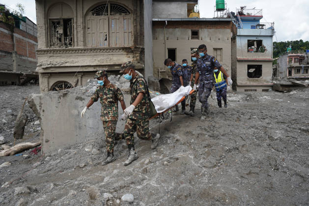 September 4, 2026, Nuwakot, Bagmati, Nepal: Following the devastating floods in Nepal, personnel from the Nepal Army and Nepal Police are carrying body on stretcher through the disaster-affected areas, navigating past flood-damaged houses and debris. Nuwakot Nepal - ZUMAa308 20260904_znp_a308_005 Copyright: xChandraxBahadurxAlex
