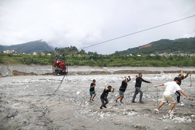 September 4, 2026, Nuwakot, Nepal: People ride on a traditional twin to get across the swollen Trishuli River following devastating flash floods that swept through the area in Nuwakot, Nepal, on Friday, September 4, 2026. The floods have left 1,287 people dead and 5,083 missing, while 13,093 people have been rescued as search and rescue operations continue. Nuwakot Nepal - ZUMAg200 20260904_zap_g200_001 Copyright: xSkandaxGautamx
