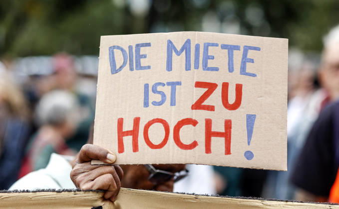 Rent Protest: Protester holding a sign reading The rent is too high during a demonstration against high rents and gentrification and in favor of expropriating housing cooperatives; thousands of people protested in Berlin on September 5, 2026, Berlin, Berlin, Germany