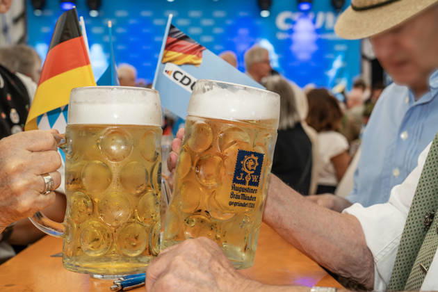 Visitors clink glasses with two Maß of Radler at the CSU Munich West Political Morning Beer Gathering, Aubing Autumn Festival, festival tent, Munich, September 5, 2026; Germany, Munich, September 5, 2026, Visitors toast each other with two Radler Maß at the CSU Mu