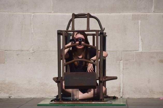 September 6, 2026, London, United Kingdom: Activist Michelle Farnham sits inside a farrowing crate in Trafalgar Square on the sixth day of the protest against farrowing crates and factory farming organised by the animal rights group Animal Rising..The activist plans to spend a total of three weeks in the cramped crate, demonstrating how mother pigs live on factory farms. London United Kingdom  - ZUMAs197 20260906_aaa_s197_035 Copyright: xVukxValcicx