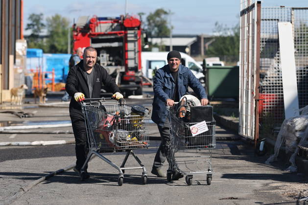 RUSSIA, MARIUPOL - SEPTEMBER 7, 2026: Local men are seen outside the Galaktika shopping centre damaged in a Ukrainain drone attack. Dmitry Yagodkin TASS  97290980