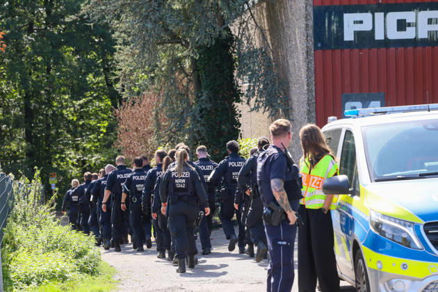 Verdächtiger Mann an Umspannwerk in Wuppertal-Ronsdorf entdeckt Aufmerksamen Zeugen fiel am Montagmorgen (07.09.2026) gegen 10:50 Uhr ein Mann mit Rucksack auf, welcher sich an einem Umspannwerk an der Lüttringhauser Straße in Wuppertal-Ronsdorf verdächtig verhielt. Nachdem er auf die Zeugen aufmerksam wurde, flüchtete er in ein angrenzendes Waldgebiet auf Remscheider Stadtgebiet, die Polizei löste aufgrund der aktuell angespannten Lage umgehend Großalarm aus. Kräfte aus Wuppertal und Remscheid umstellten das Waldgebiet und forderten weitere Kräfte zur Unterstützung an, daher kam auch eine Einsatzhundertschaft aus Dortmund zum Einsatz um den Wald zu durchsuchen. Neben zwei Polizeihubschraubern kam auch eine Drohne der Polizei zu