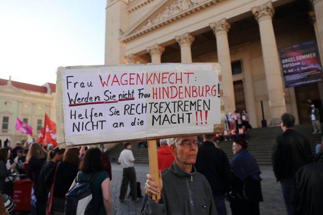 A protester holding a sign reading Ms. Wagenknecht, don’t become Ms. Hindenburg—don’t help the far right come to power during a rally against the Alternative for Germany (AfD) party following its victory in the state election in Saxony-Anhalt, Alter Markt, Potsdam, September 7, 2026. Rally against the AfD in Potsdam
