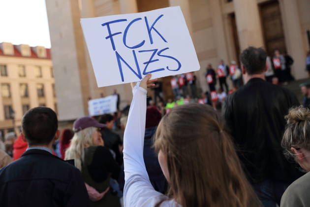 A protester holding a sign reading FCK NZS during a rally against the Alternative for Germany (AfD) party following its victory in the state election in Saxony-Anhalt, Alter Markt, Potsdam, September 7, 2026. Rally against the AfD in Potsdam