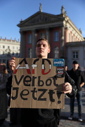A protester holding a sign reading Ban the AfD Now during a rally against the Alternative for Germany (AfD) party following its victory in the state election in Saxony-Anhalt, Alter Markt, Potsdam, September 7, 2026. Rally against the AfD in Potsdam