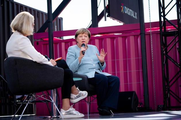 Digital X 2026: Dr. Angela Merkel, former German Chancellor, gesturing and holding a microphone, alongside Prof. Dr. Miriam Meckel,