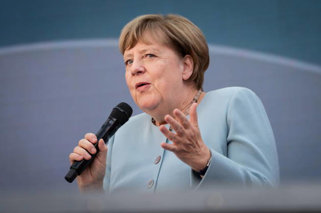 Digital X 2026: Dr. Angela Merkel, former German Chancellor, smiling slightly with a special gesture on the Harbor Stage at Digital X 2026. DIGITAL X is Europe’s leading cross-industry digitaliza
