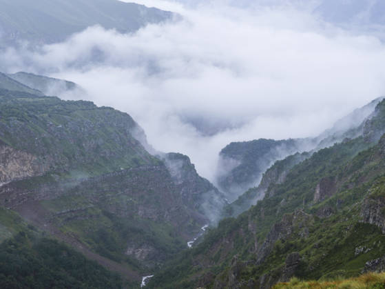 Creative Highlights World Caucasus Mountains Georgia Expedition A view shows a deep mountain gorge filled with low-hanging clouds close to the Dariali Gorge in the Caucasus Mountains near Stepantsminda, Georgia, on August 31, 2026. Mount Kazbek, a 5,054-meter-high extinct stratovolcano in the Caucasus Mountains along the border between Georgia and Russia, is a premier destination for international trekkers and mountaineers. The nearby town of Stepantsminda and landmarks such as the 14th-century Gergeti Trinity Church and the Soviet-era Bethlemi Hut serve as critical staging and acclimatization areas for high-altitude expeditions facing volatile alpine weather. Stepantsminda Mtskheta-Mtianeti Georgia Copyright: xTolgaxSezginx