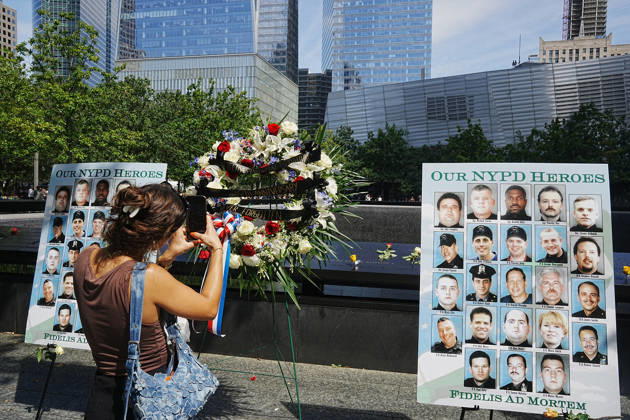 September 9, 2026, New York, New York, USA: Visitors look over a memorial and flower arrangement to the NYPD along the South Tower reflecting pool ahead of the 25th anniversary of the attacks of September 11 at the 9 11 Memorial on September 9, 2026 in New York. New York USA - ZUMAb148 20260909_zap_b148_031 Copyright: xBryanxSmithx