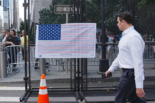 September 9, 2026, New York, New York, USA: A man walks past a Flag of Honor on a security fence ahead of the 25th anniversary of the attacks of September 11 at the 9 11 Memorial in lower Manhattan on September 9, 2026 in New York. New York USA - ZUMAb148 20260909_zap_b148_067 Copyright: xBryanxSmithx