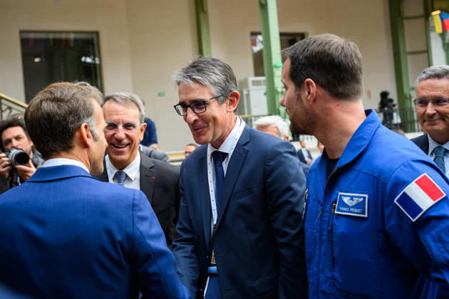 SIE International Space Summit - Paris French President Emmanuel Macron, greets Patrick Caine, CEO of Thales, in the presence of astronaut Thomas Pesquet, during the International Space Summit at Grand Palais in Paris, France on April 14, 2026. Photo by Eric Tschaen Pool ABACAPRESS.COM Paris IDF France  Copyright: xTschaenxEric Pool ABACAx