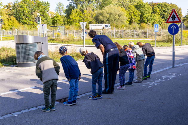 Augsburg, Bavaria, Germany - September 11, 2026: School safety training with the Augsburg Traffic Police ahead of the start of the school year in Bavaria. During the school safety training in Augsburg, children practice crossing the street safely with a police officer. Before crossing, they look carefully to the left and right and learn proper traffic behavior
