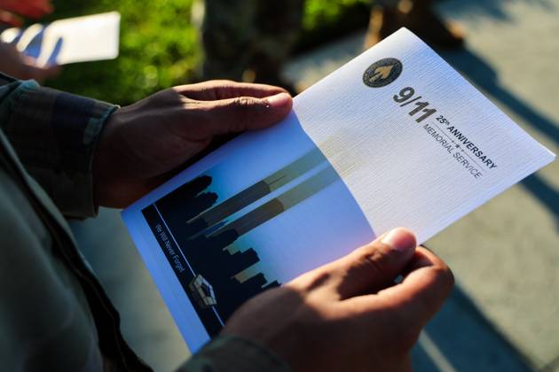 September 11, 2026, Tampa, Florida, USA: A member of the military community holds a program for the 9 11 25th Anniversary Memorial Service hosted by U.S. Special Operations Command (USSOCOM) to honor the 25th anniversary of the Sept. 11 terrorist attacks at the MacDill AFB Special Operations Forces Memorial on Friday, Sept. 11, 2026 in Tampa. Attendees honored the nearly 3,000 victims of the Sept. 11 attacks and reflect on the enduring legacy and resolve of the SOF community. Tampa USA - ZUMAs70_ 20260911_zan_s70_001 Copyright: xDirkxShaddx