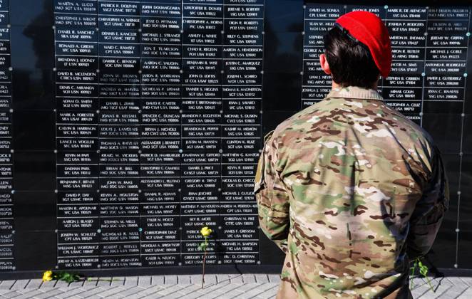 September 11, 2026, Tampa, Florida, USA: A members of the military community reflects on the dedicated wall honoring roughly 1,900 fallen special operations service members during the 9 11 25th Anniversary Memorial Service hosted by U.S. Special Operations Command (USSOCOM) to honor the 25th anniversary of the Sept. 11 terrorist attacks at the MacDill AFB Special Operations Forces Memorial on Friday, Sept. 11, 2026 in Tampa. Tampa USA - ZUMAs70_ 20260911_zan_s70_011 Copyright: xDirkxShaddx