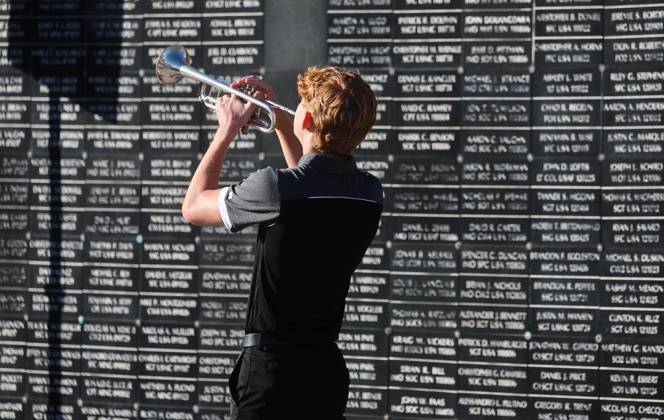 September 11, 2026, Tampa, Florida, USA: Wilson Poe, with the Berkeley Preparatory School Marching Buccaneers, performs TAPS with the dedicated wall honoring roughly 1,900 fallen special operations service members, in the background, during the 9 11 25th Anniversary Memorial Service hosted by U.S. Special Operations Command (USSOCOM) to honor the 25th anniversary of the Sept. 11 terrorist attacks at the MacDill AFB Special Operations Forces Memorial on Friday, Sept. 11, 2026 in Tampa. Tampa USA - ZUMAs70_ 20260911_zan_s70_015 Copyright: xDirkxShaddx