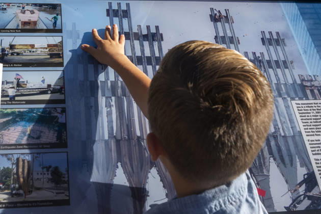September 11, 2026, Los Angeles, California, USA: A boy examines a 9 11 memorial display featuring images of the World Trade Center site as the Los Angeles Fire Department marks the 25th anniversary of the terrorist attacks at the Frank Hotchkin Memorial Training Center in Los Angeles, California, on Sept. 11, 2026. Los Angeles USA  - ZUMAc68_ 20260911_zaf_c68_012 Copyright: xRingoxChiux