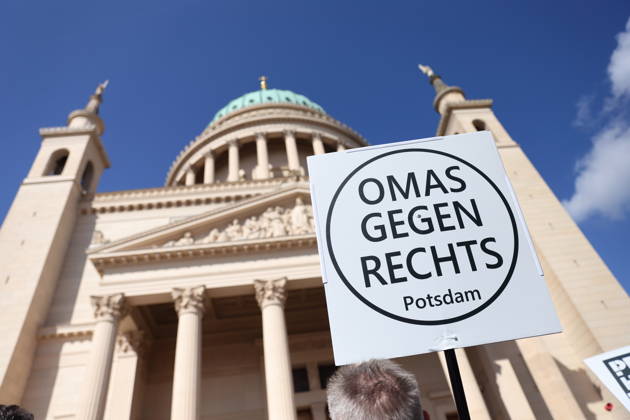 A protester holding a sign reading Grandmas Against the Right Potsdam during a demonstration calling for the Federal Constitutional Court to review far-right parties, Alter Markt, Potsdam, September 12, 2026: Protest in Potsdam
