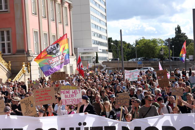 Protesters carrying a banner reading Review today, Schütz tomorrow march around the state parliament during a demonstration calling for the Federal Constitutional Court to review far-right parties, Alter Markt, Potsdam, September 12, 2026. Review demonstration in Potsdam