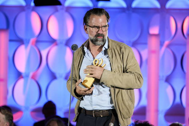 2026 German Acting Award: Rick Ostermann accepting the award on behalf of winner Armin Rohde; Stage show celebrating 15 years of the German Acting Award and 20 years of the BFFS; Pullman Berlin Schweizerhof; Date: September 11, 2026 Copyright: xEventpressx