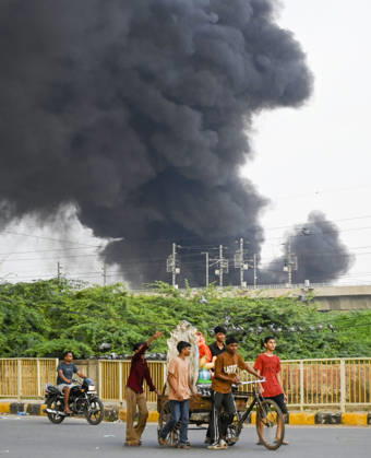 NEW DELHI, INDIA - SEPTEMBER 13: A fire breaks out at a plywood warehouse in Dallupura, East Delhi, sending thick smoke into the sky that is visible from several kilometres away, on September 13, 2026 in New Delhi, India. The fire department received a call about the blaze at 3.20 pm, following which 12 fire tenders were rushed to the spot. Firefighters were present at the site and were working to control the blaze. (Photo by Sanjeev Verma Hindustan Times ) Massive Fire Breaks Out At Delhi Plywood Warehouse, 12 Fire Tenders Rushed