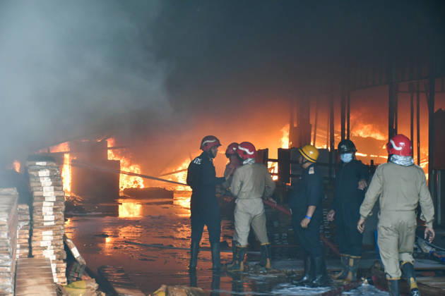 NEW DELHI, INDIA - SEPTEMBER 13: Firefighters work to extinguish a massive blaze at a plywood warehouse in Dallupura, East Delhi, as thick plumes of smoke billow into the sky and remain visible from several kilometres away, on September 13, 2026 in New Delhi, India. The fire department received a call about the blaze at 3.20 pm, following which 12 fire tenders were rushed to the spot. Firefighters were present at the site and were working to control the blaze. (Photo by Sanjeev Verma Hindustan Times ) Massive Fire Breaks Out At Delhi Plywood Warehouse, 12 Fire Tenders Rushed
