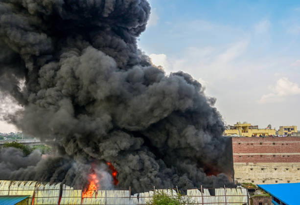 NEW DELHI, INDIA - SEPTEMBER 13: A fire breaks out at a plywood warehouse in Dallupura, East Delhi, sending thick smoke into the sky that is visible from several kilometres away, on September 13, 2026 in New Delhi, India. The fire department received a call about the blaze at 3.20 pm, following which 12 fire tenders were rushed to the spot. Firefighters were present at the site and were working to control the blaze. (Photo by Sunil Ghosh Hindustan Times ) Massive Fire Breaks Out At Delhi Plywood Warehouse, 12 Fire Tenders Rushed