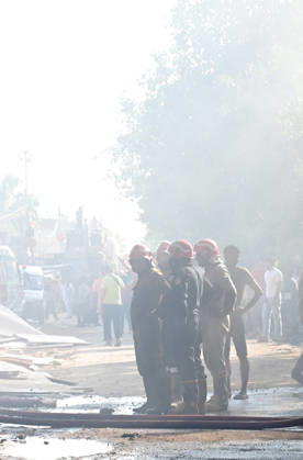 NEW DELHI, INDIA - SEPTEMBER 13: Firefighters work to extinguish a massive blaze at a plywood warehouse in Dallupura, East Delhi, as thick plumes of smoke billow into the sky and remain visible from several kilometres away, on September 13, 2026 in New Delhi, India. The fire department received a call about the blaze at 3.20 pm, following which 12 fire tenders were rushed to the spot. Firefighters were present at the site and were working to control the blaze. (Photo by Sunil Ghosh Hindustan Times ) Massive Fire Breaks Out At Delhi Plywood Warehouse, 12 Fire Tenders Rushed