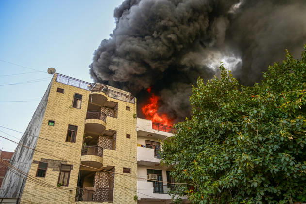 NEW DELHI, INDIA - SEPTEMBER 13: Firefighters work to extinguish a massive blaze at a plywood warehouse in Dallupura, East Delhi, as thick plumes of smoke billow into the sky and remain visible from several kilometres away, on September 13, 2026 in New Delhi, India. The fire department received a call about the blaze at 3.20 pm, following which 12 fire tenders were rushed to the spot. Firefighters were present at the site and were working to control the blaze. (Photo by Sunil Ghosh Hindustan Times ) Massive Fire Breaks Out At Delhi Plywood Warehouse, 12 Fire Tenders Rushed