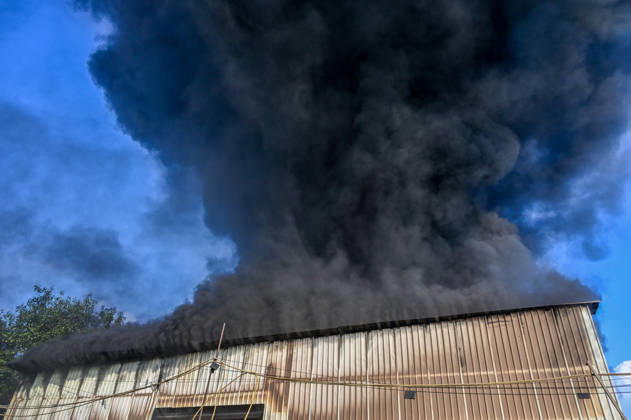NEW DELHI, INDIA - SEPTEMBER 13: Firefighters work to extinguish a massive blaze at a plywood warehouse in Dallupura, East Delhi, as thick plumes of smoke billow into the sky and remain visible from several kilometres away, on September 13, 2026 in New Delhi, India. The fire department received a call about the blaze at 3.20 pm, following which 12 fire tenders were rushed to the spot. Firefighters were present at the site and were working to control the blaze. (Photo by Sunil Ghosh Hindustan Times ) Massive Fire Breaks Out At Delhi Plywood Warehouse, 12 Fire Tenders Rushed