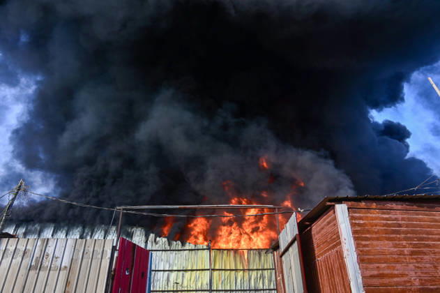 NEW DELHI, INDIA - SEPTEMBER 13: Firefighters work to extinguish a massive blaze at a plywood warehouse in Dallupura, East Delhi, as thick plumes of smoke billow into the sky and remain visible from several kilometres away, on September 13, 2026 in New Delhi, India. The fire department received a call about the blaze at 3.20 pm, following which 12 fire tenders were rushed to the spot. Firefighters were present at the site and were working to control the blaze. (Photo by Sunil Ghosh Hindustan Times ) Massive Fire Breaks Out At Delhi Plywood Warehouse, 12 Fire Tenders Rushed