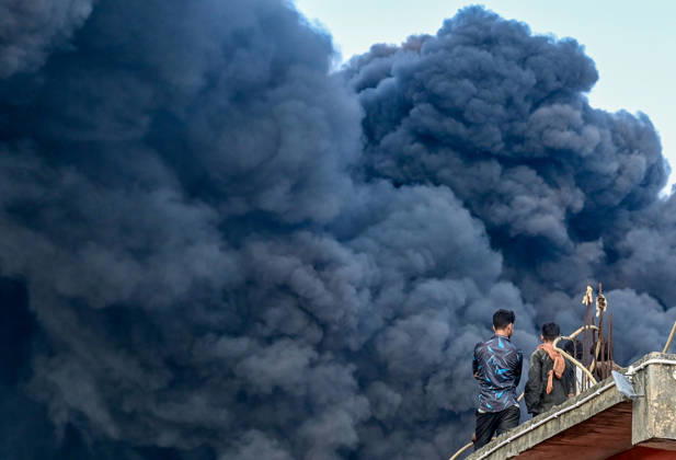 NEW DELHI, INDIA - SEPTEMBER 13: Firefighters work to extinguish a massive blaze at a plywood warehouse in Dallupura, East Delhi, as thick plumes of smoke billow into the sky and remain visible from several kilometres away, on September 13, 2026 in New Delhi, India. The fire department received a call about the blaze at 3.20 pm, following which 12 fire tenders were rushed to the spot. Firefighters were present at the site and were working to control the blaze. (Photo by Sunil Ghosh Hindustan Times ) Massive Fire Breaks Out At Delhi Plywood Warehouse, 12 Fire Tenders Rushed