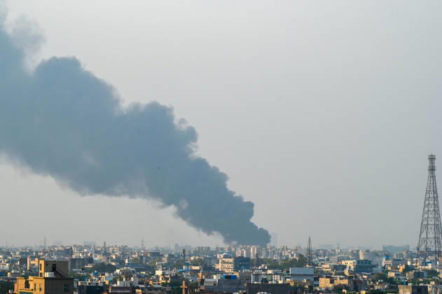 NEW DELHI, INDIA - SEPTEMBER 13: A fire breaks out at a plywood warehouse in Dallupura, East Delhi, sending thick smoke into the sky that is visible from several kilometres away, on September 13, 2026 in New Delhi, India. The fire department received a call about the blaze at 3.20 pm, following which 12 fire tenders were rushed to the spot. Firefighters were present at the site and were working to control the blaze. (Photo by Sunil Ghosh Hindustan Times ) Massive Fire Breaks Out At Delhi Plywood Warehouse, 12 Fire Tenders Rushed
