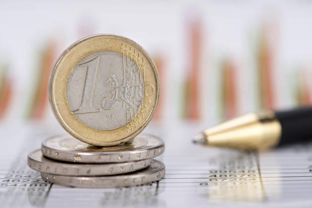 Close-up of a Euro Coin: A single Euro coin is shown in close-up on a stock market chart. FOR EDITORIAL USE ONLY
