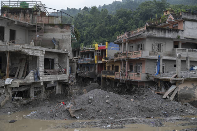 Aftermath of the devastating flash floods in Nepal NUWAKOT, NEPAL - SEPTEMBER 15: A view of the submerged landscape following the devastating flash floods on August 26 that struck Devighat, Nuwakot, Nepal, on September 15, 2026. People in the affected areas of Nuwakot continue to return in search of their destroyed homes and the last remaining memories of their lives. Some are trying to recover essential belongings from the rubble, while others are working with family members to remove soil from parts of their homes buried underground and make them habitable again. The destruction in Devighat village is severe. Many multi-storey buildings have collapsed, while some have been buried under earth up to the level of their fifth floors. Religiou  Copyright: x2026xAnadoluxAbdulxGonix