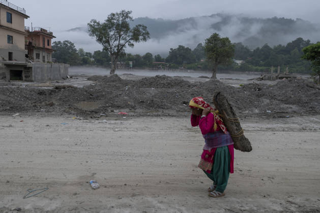 Aftermath of the devastating flash floods in Nepal NUWAKOT, NEPAL - SEPTEMBER 15: A view of the submerged landscape following the devastating flash floods on August 26 that struck Devighat, Nuwakot, Nepal, on September 15, 2026. People in the affected areas of Nuwakot continue to return in search of their destroyed homes and the last remaining memories of their lives. Some are trying to recover essential belongings from the rubble, while others are working with family members to remove soil from parts of their homes buried underground and make them habitable again. The destruction in Devighat village is severe. Many multi-storey buildings have collapsed, while some have been buried under earth up to the level of their fifth floors. Religiou  Copyright: x2026xAnadoluxAbdulxGonix